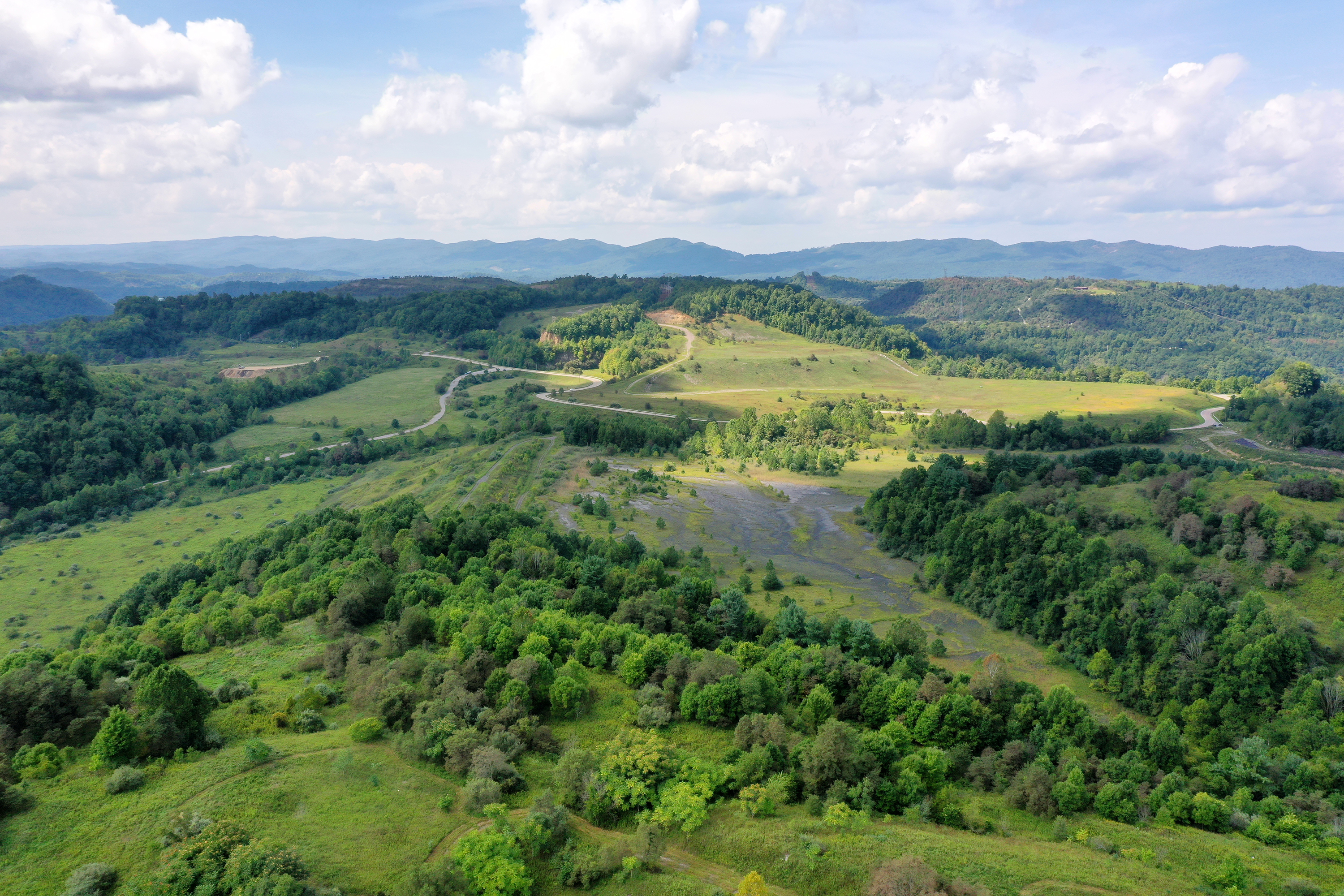 Green mountains with a former mine. 