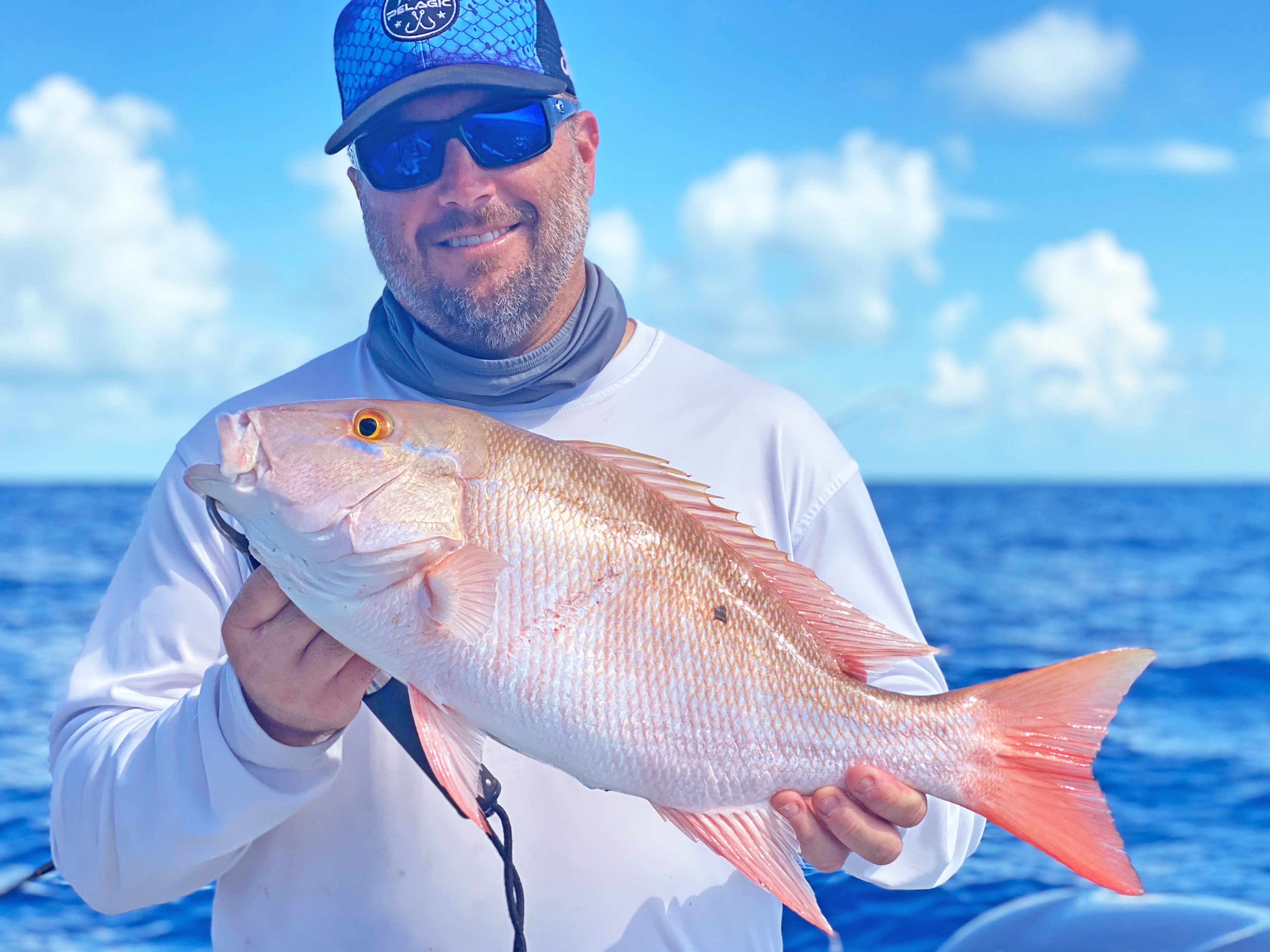 Florida fisheries manager David Moss holds a large freshly-caught mutton snapper.