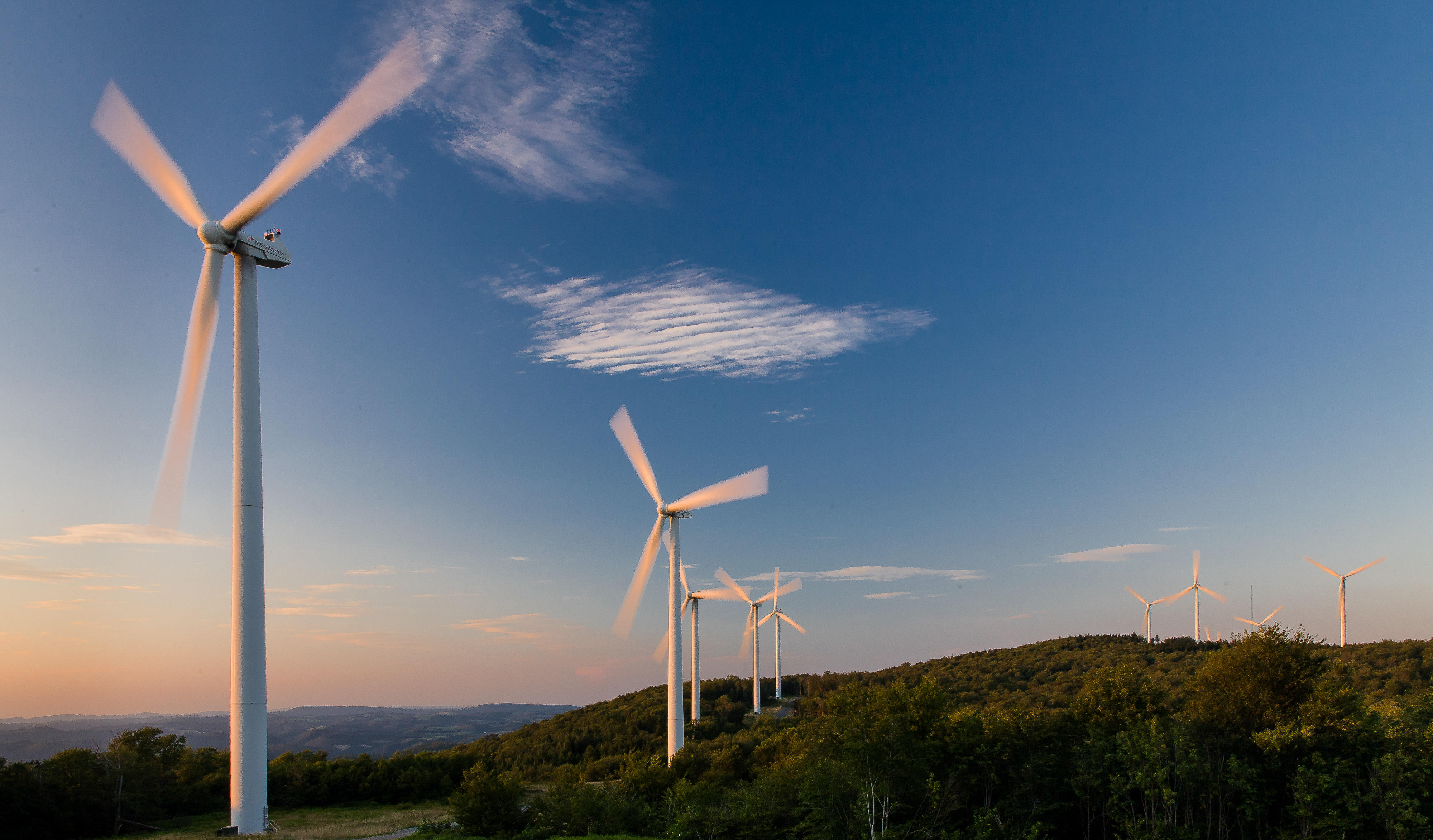 Wind turbines on the top of a hill.