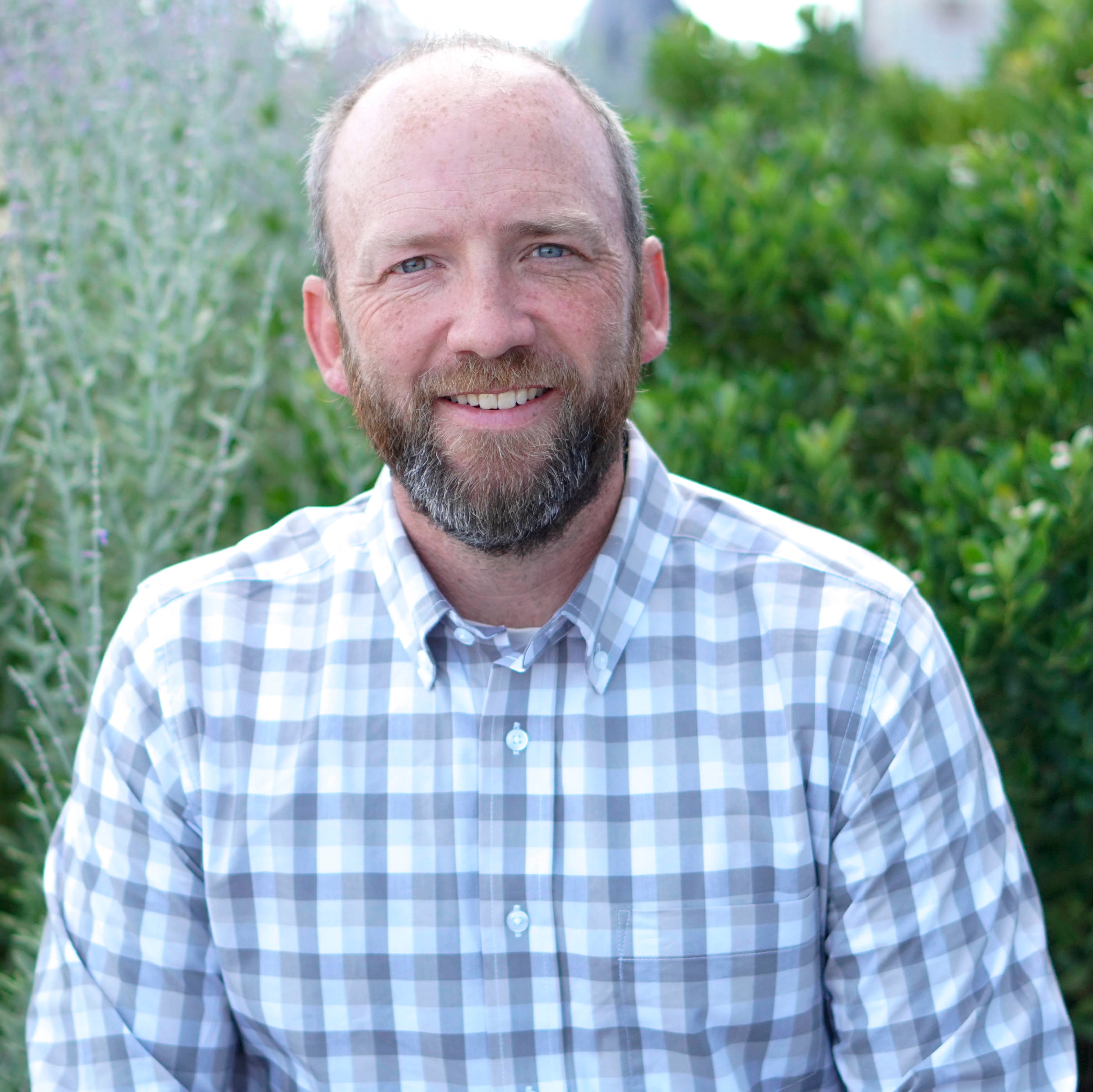 Missouri State Director Adam Mclanestands in an Iowa field.
