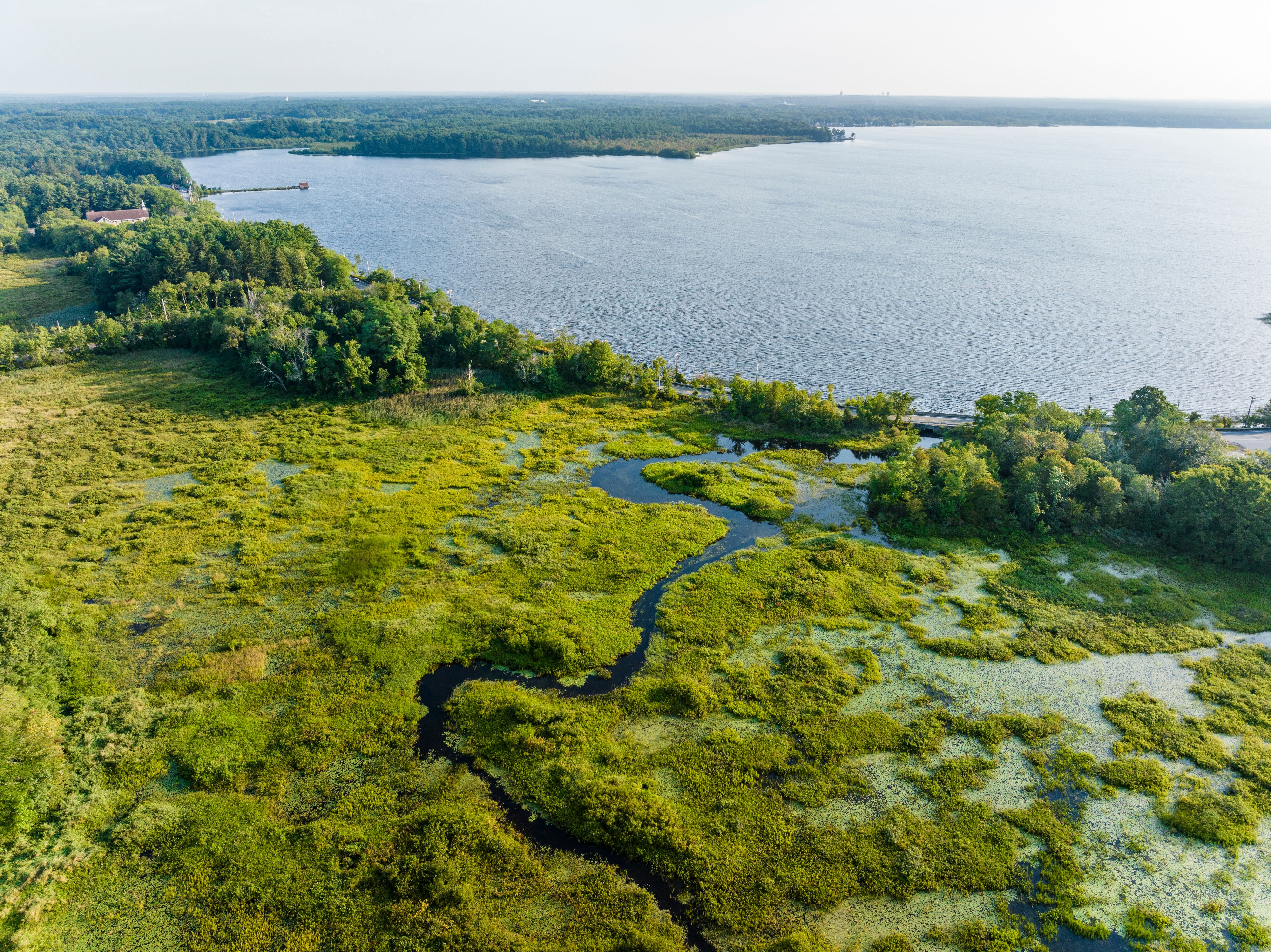 Drone view of wetlands and a river feeding into Long Pond in Lakeville, Massachusetts.