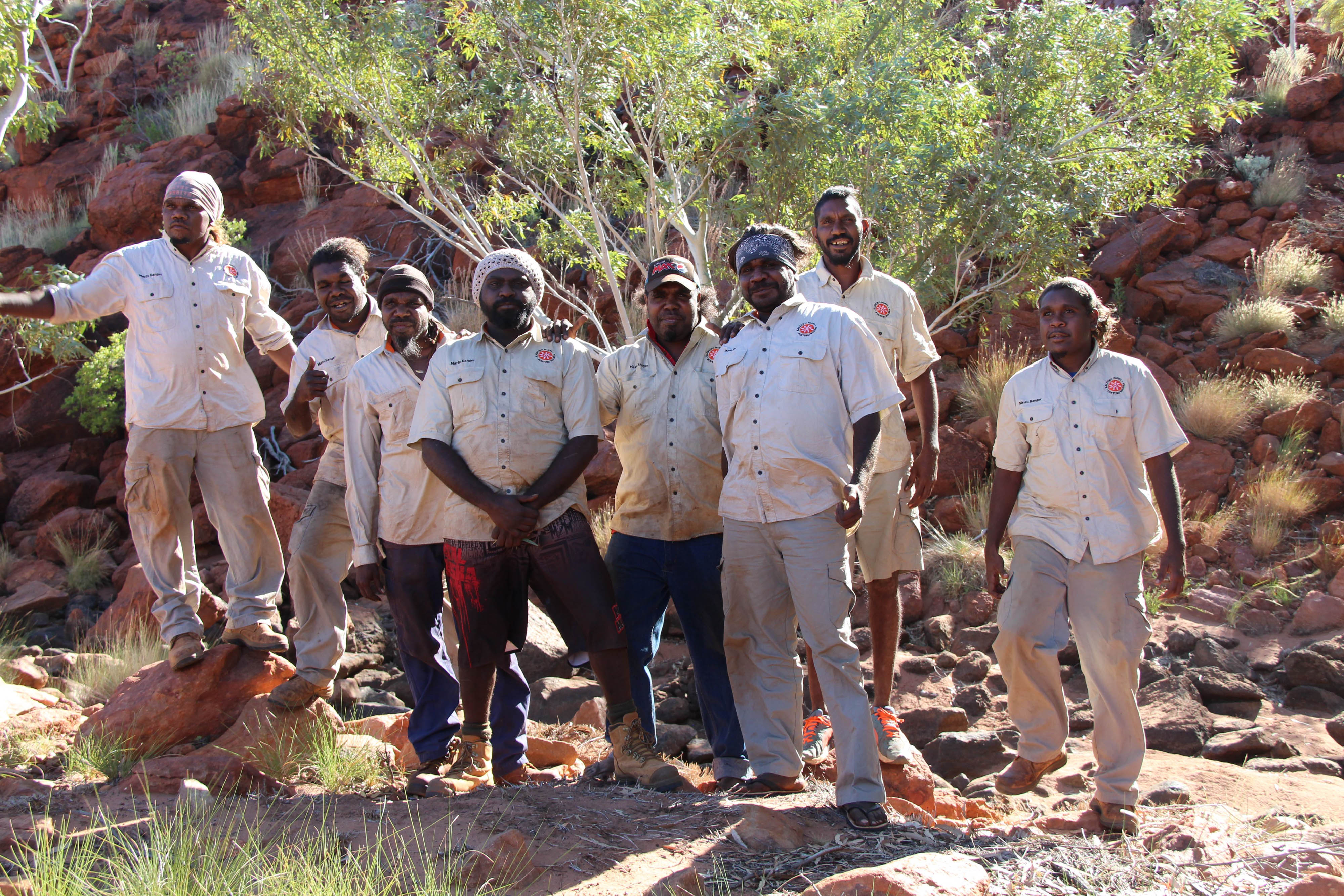 a group of people poses for an outdoor photo