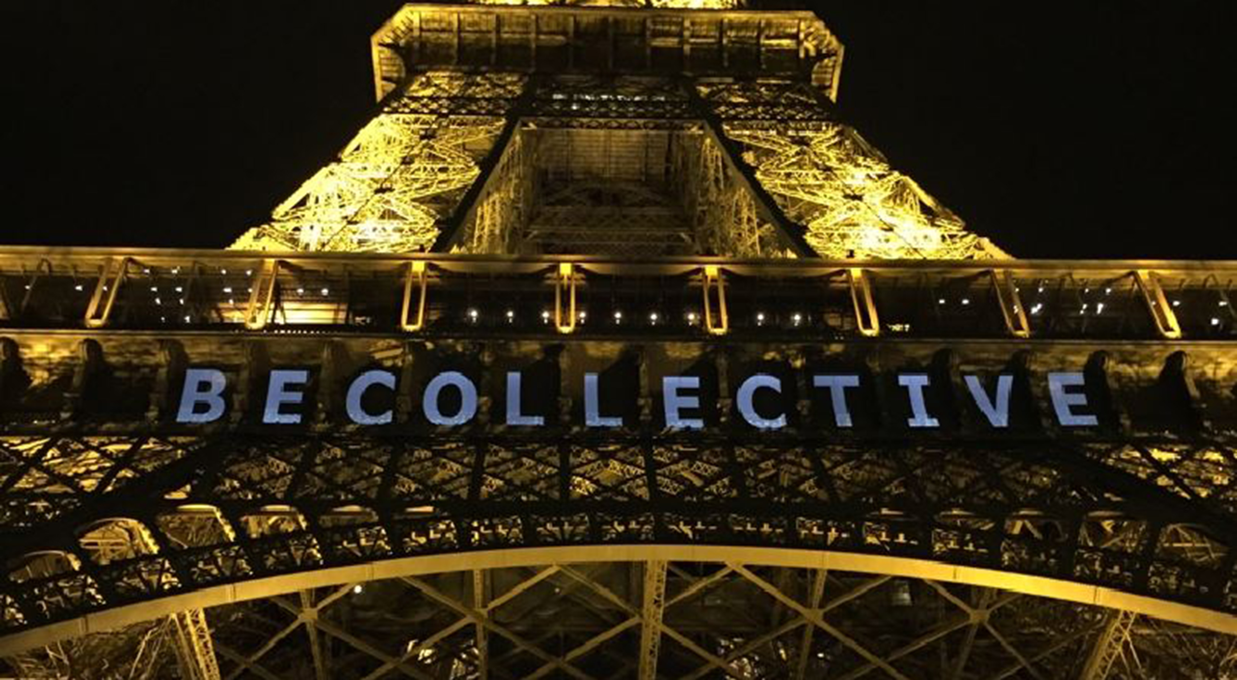 Be Collective sign under the Eiffel Tower during COP21. 