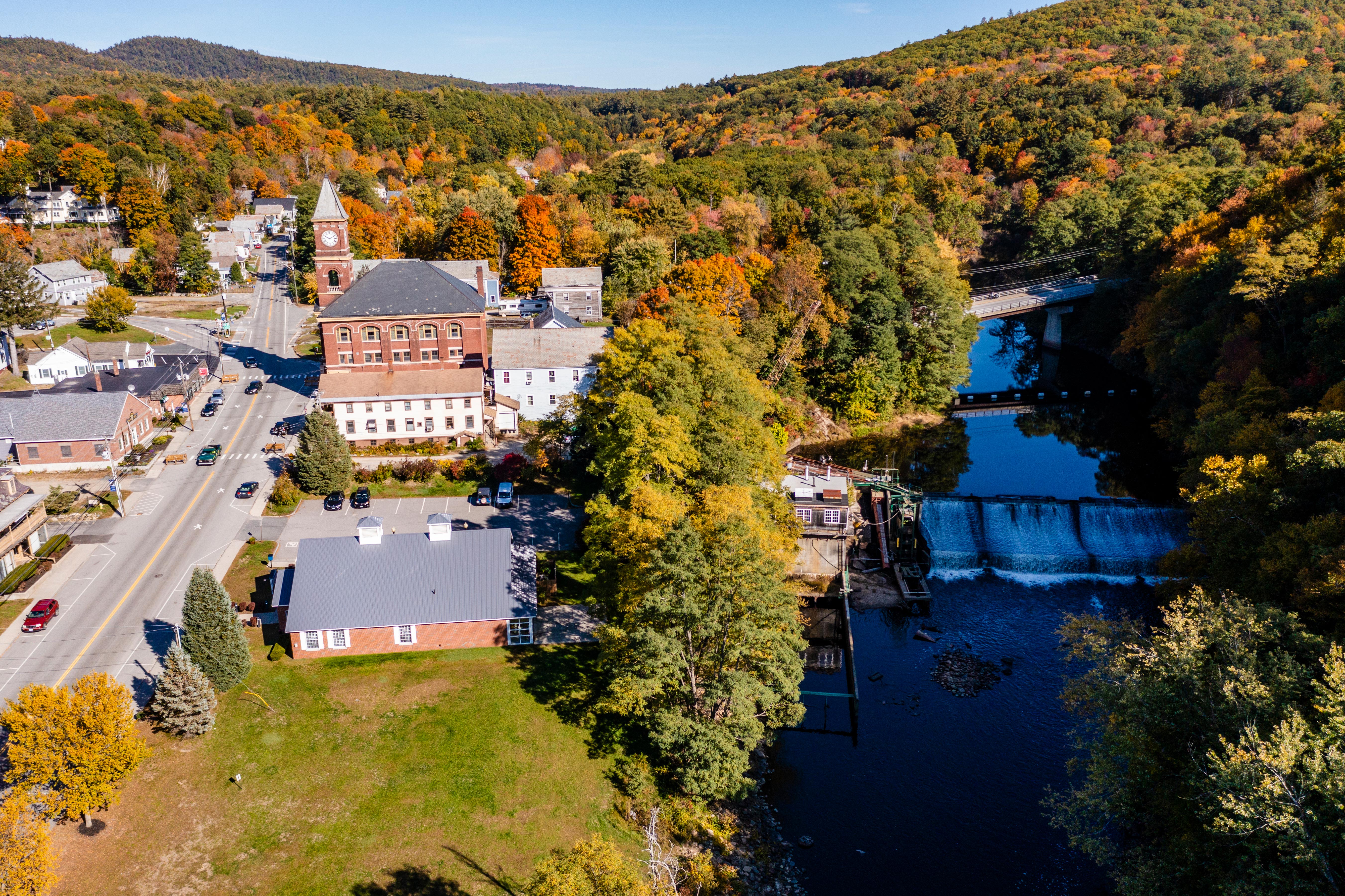 An overhead view of a dam on a river in the fall.