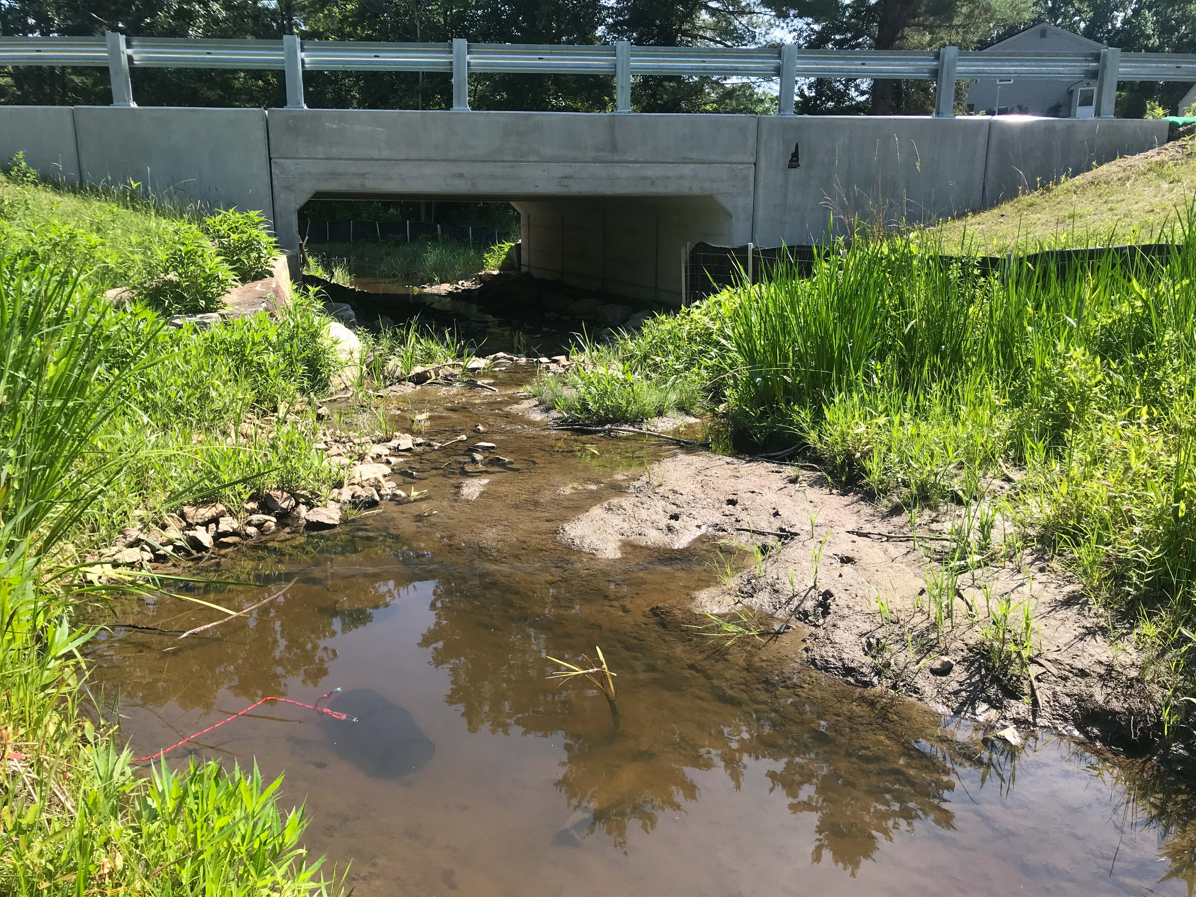 A wide box culvert over a stream.
