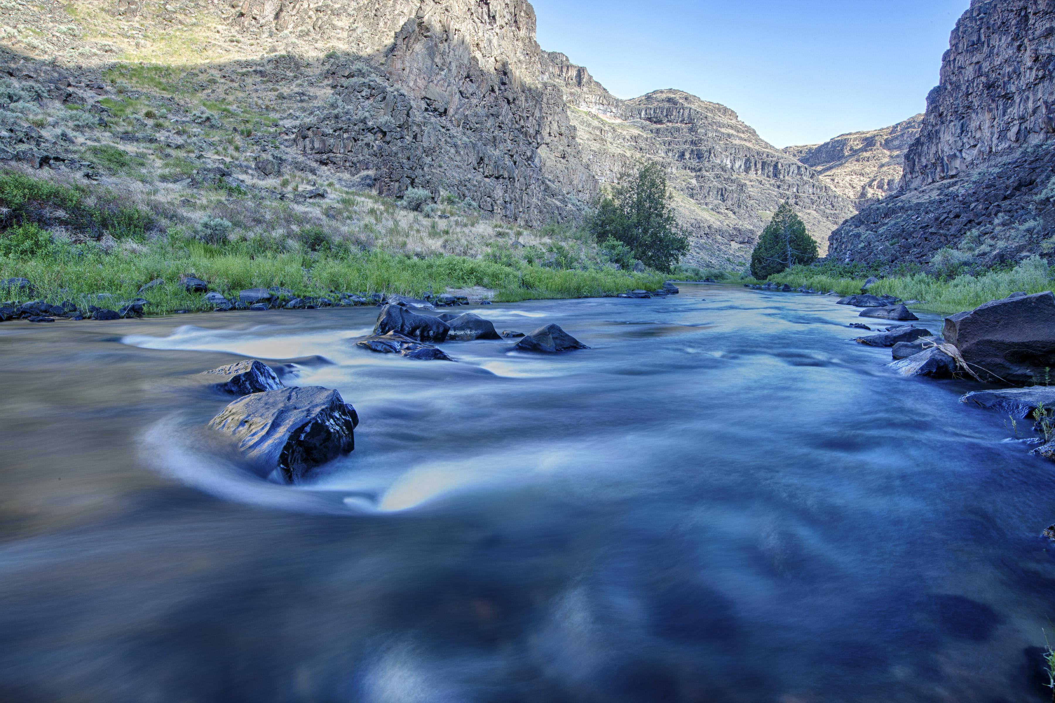 A rushing river in a narrow, mountainous canyon.