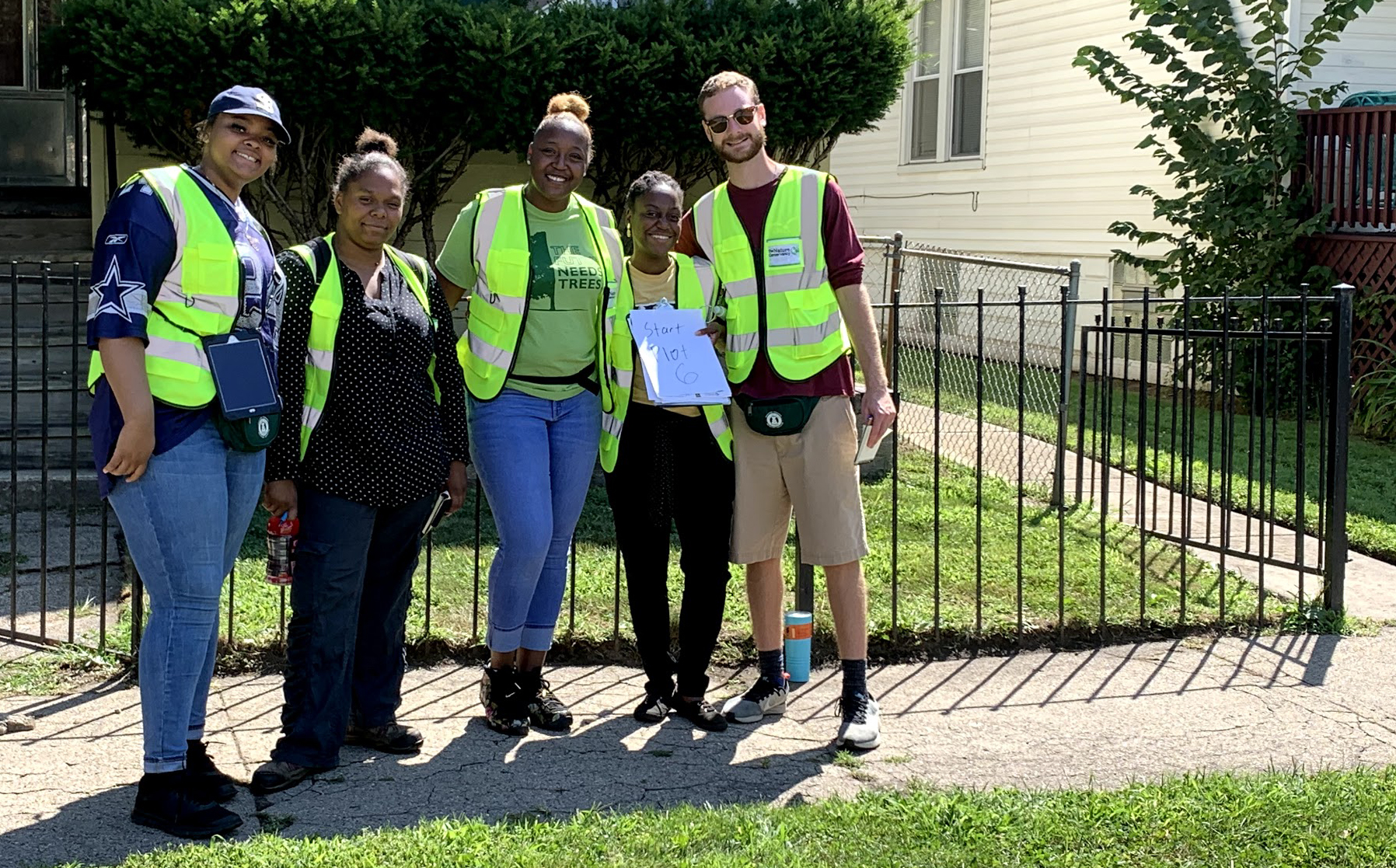 Five workers stand in front of a house in Chicago. 
