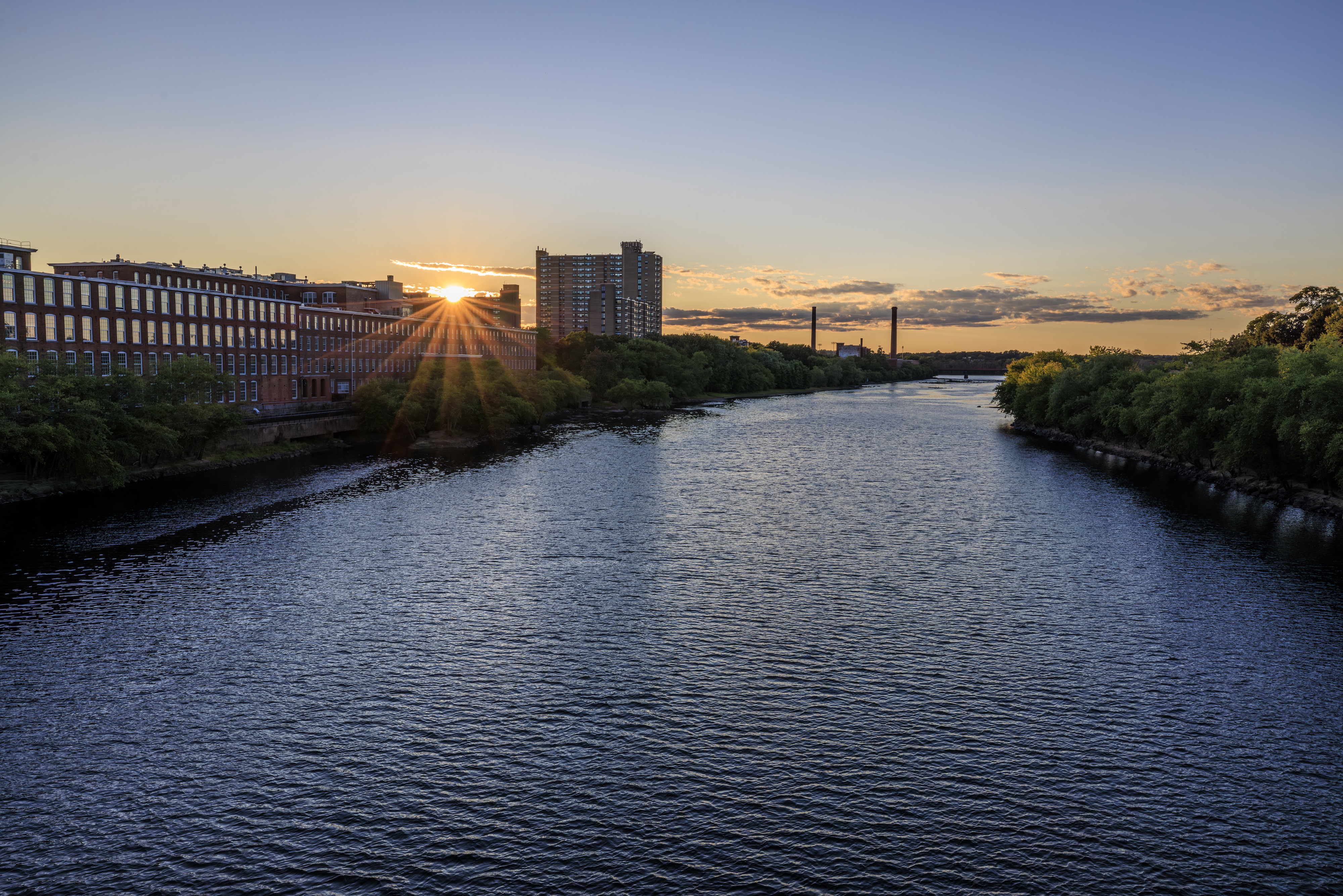 The Merrimack River along mill buildings at sunrise.