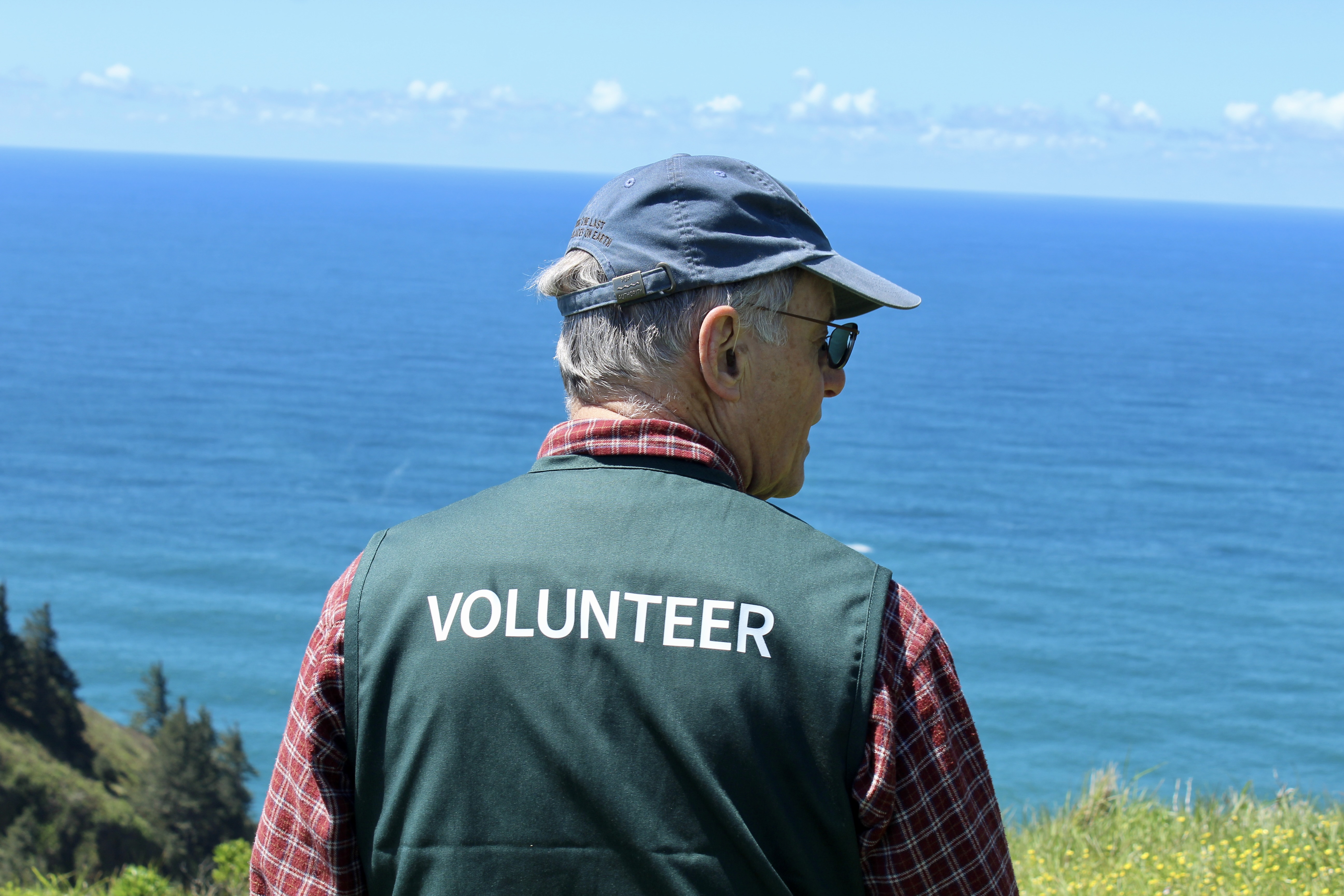 A man wearing a green vest. 