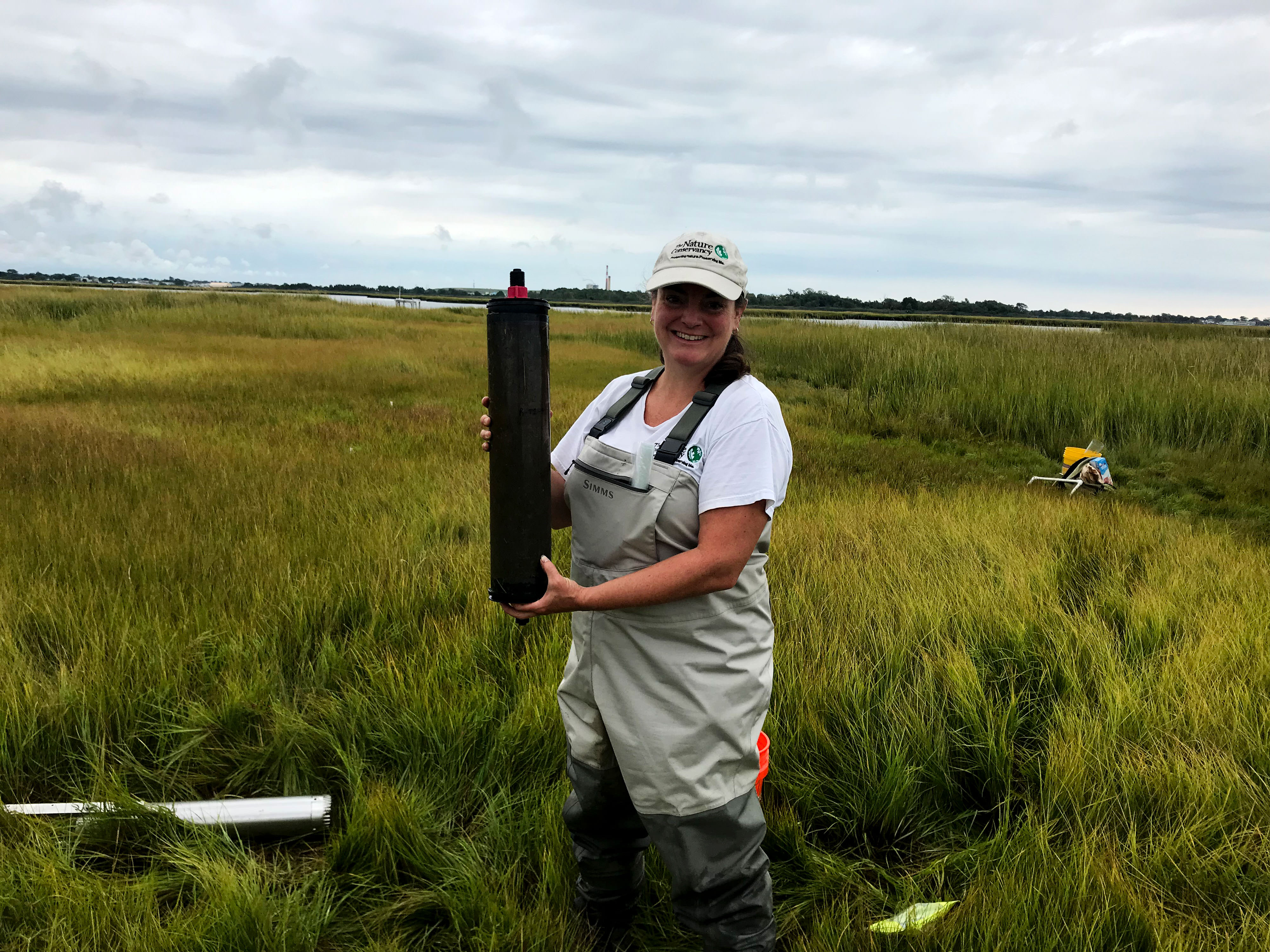 Nicole Maher poses with a salt marsh sample.