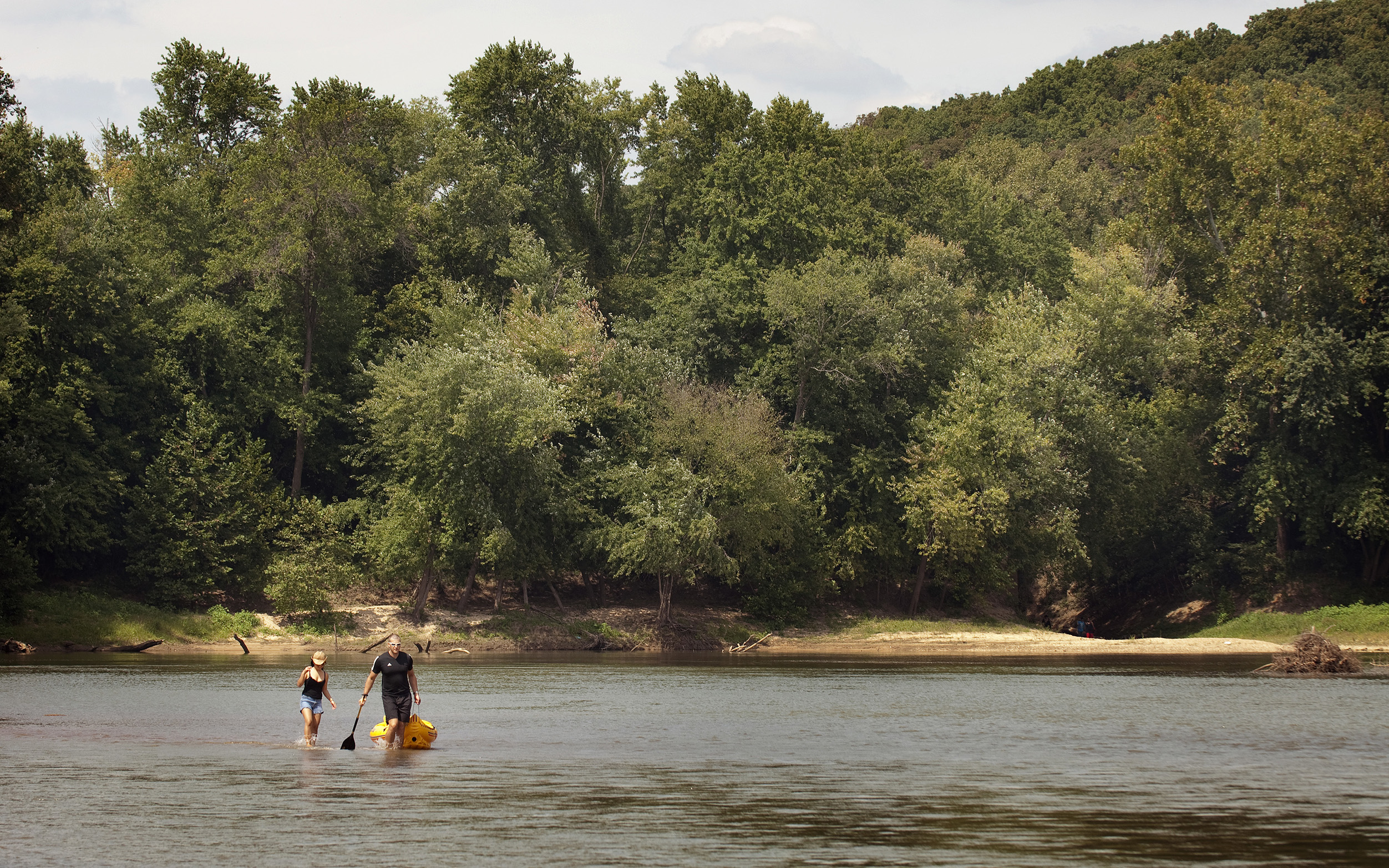 Two kayakers on a river.