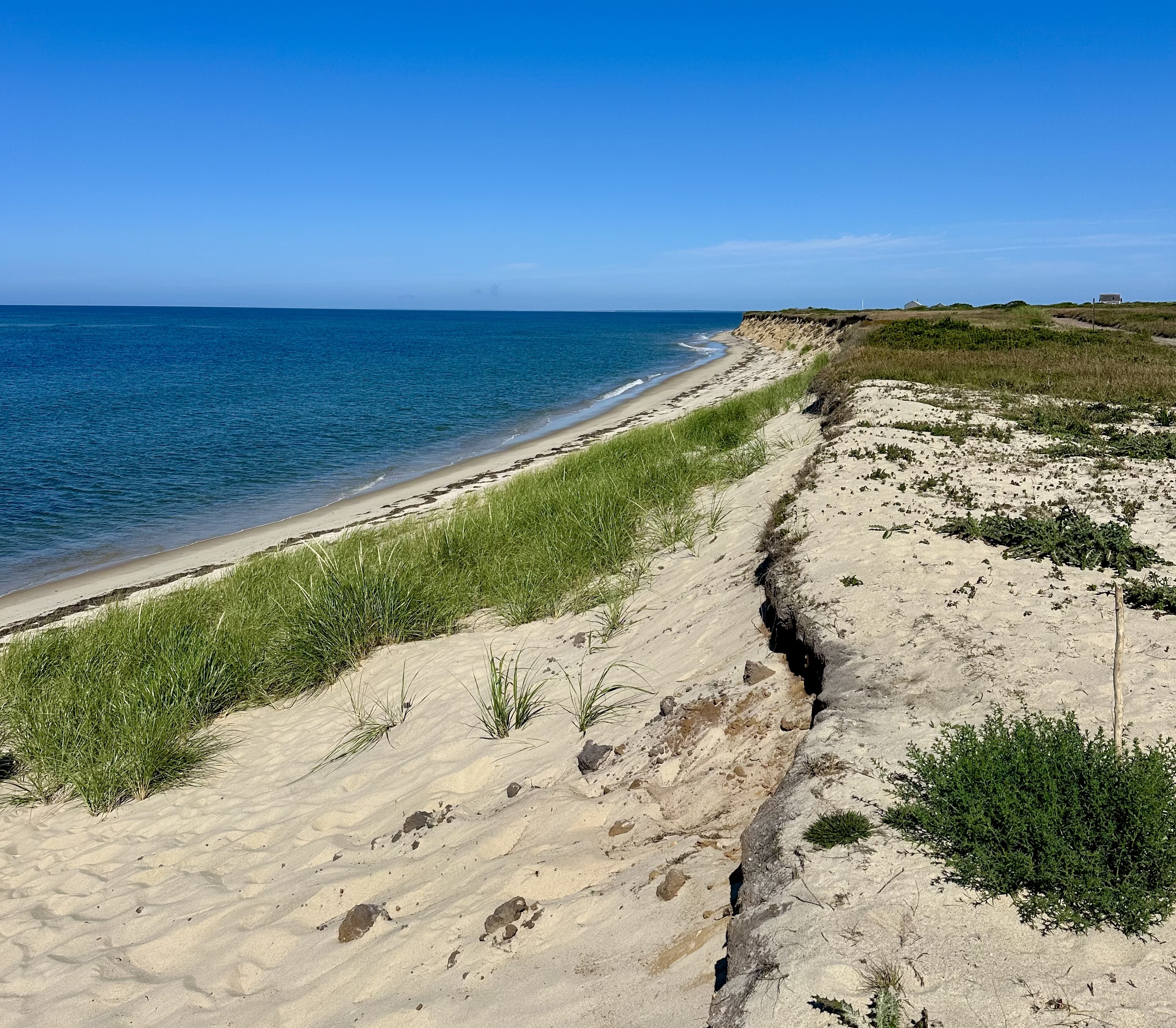 A coastal bluff on an island is falling into the ocean.