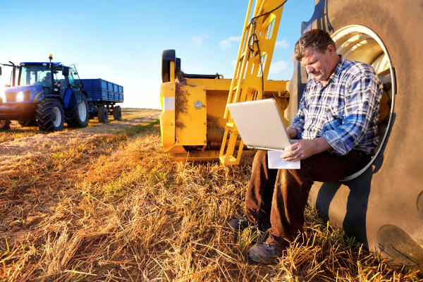 Farmer using his computer. 