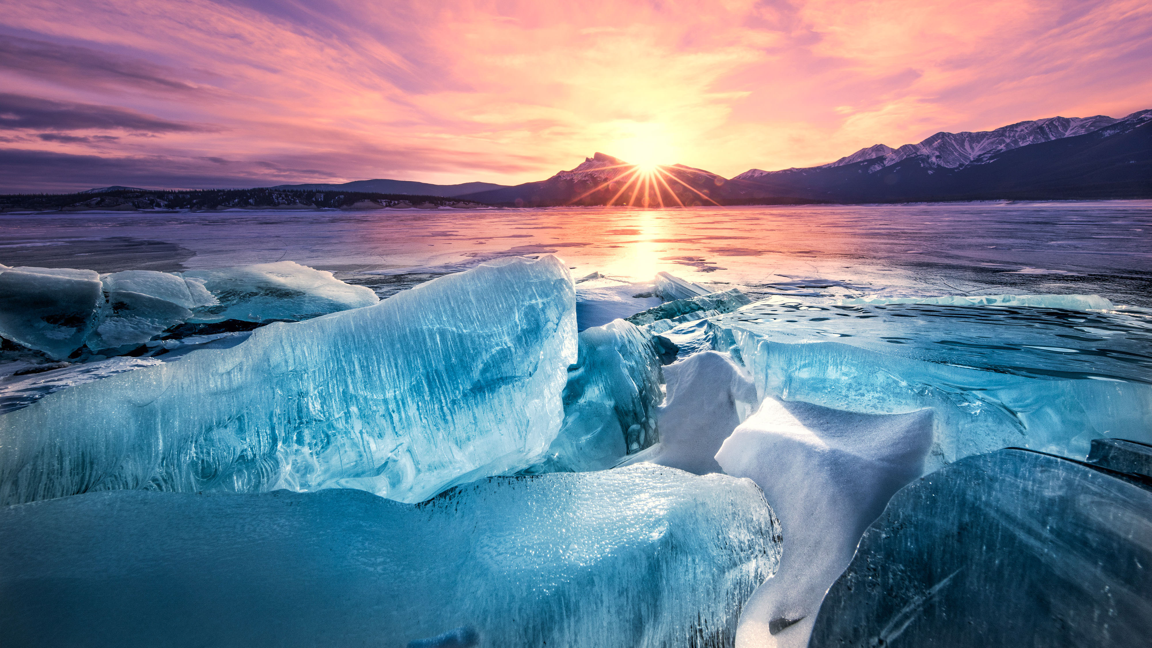 Sun low in the sky above a frozen lake in Canada.